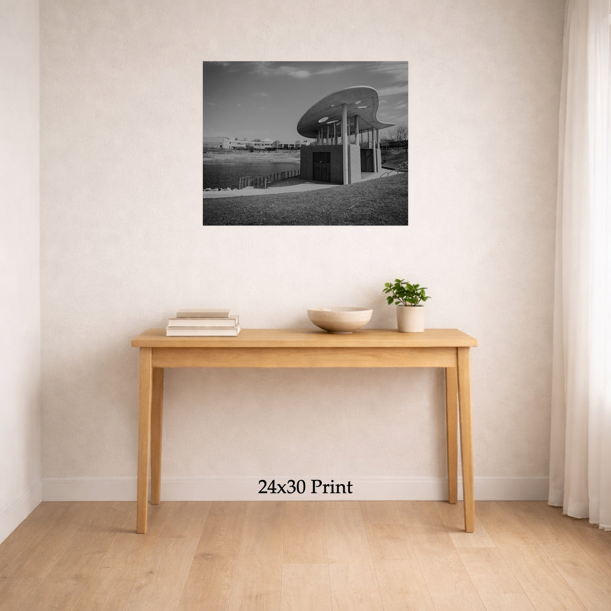 Arts By The Water as a 24x30 print on a wall above a console table, shown to scale
